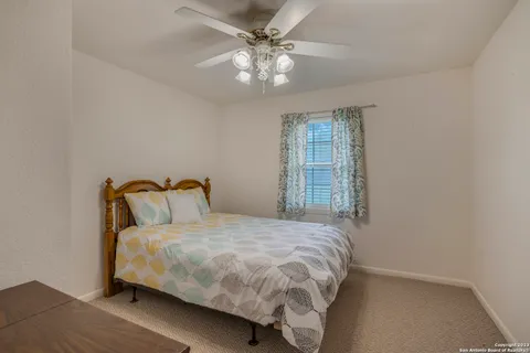 a bedroom with a bed and window