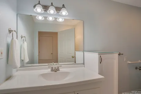 a bathroom with a sink and a mirror