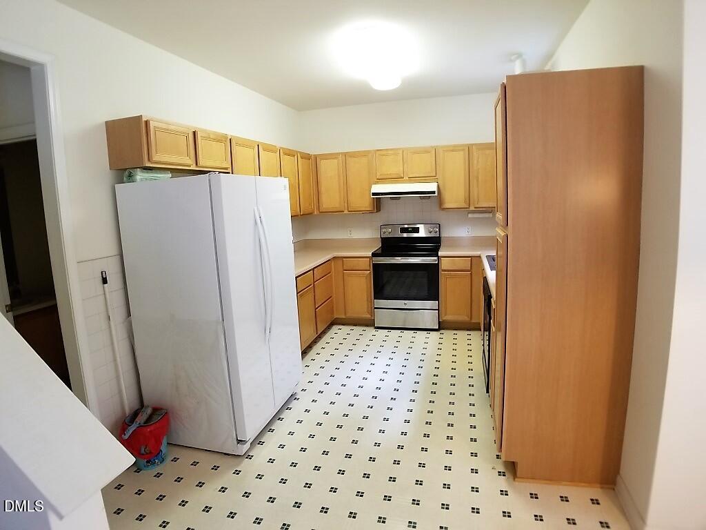 2100 Ramsgate Street Raleigh, NC 27603 - Photo 3 of 13 a kitchen with stainless steel appliances a refrigerator a stove a sink and dishwasher