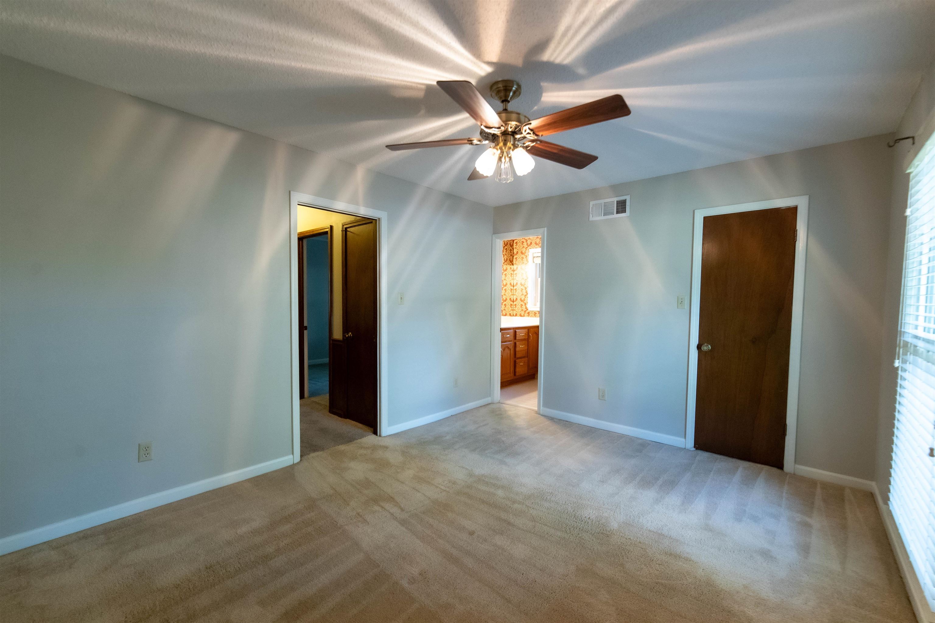 653 Oak Wild Cove Collierville, TN 38017 - Photo 14 of 20 Unfurnished bedroom with light carpet, a closet, ceiling fan, and ensuite bathroom