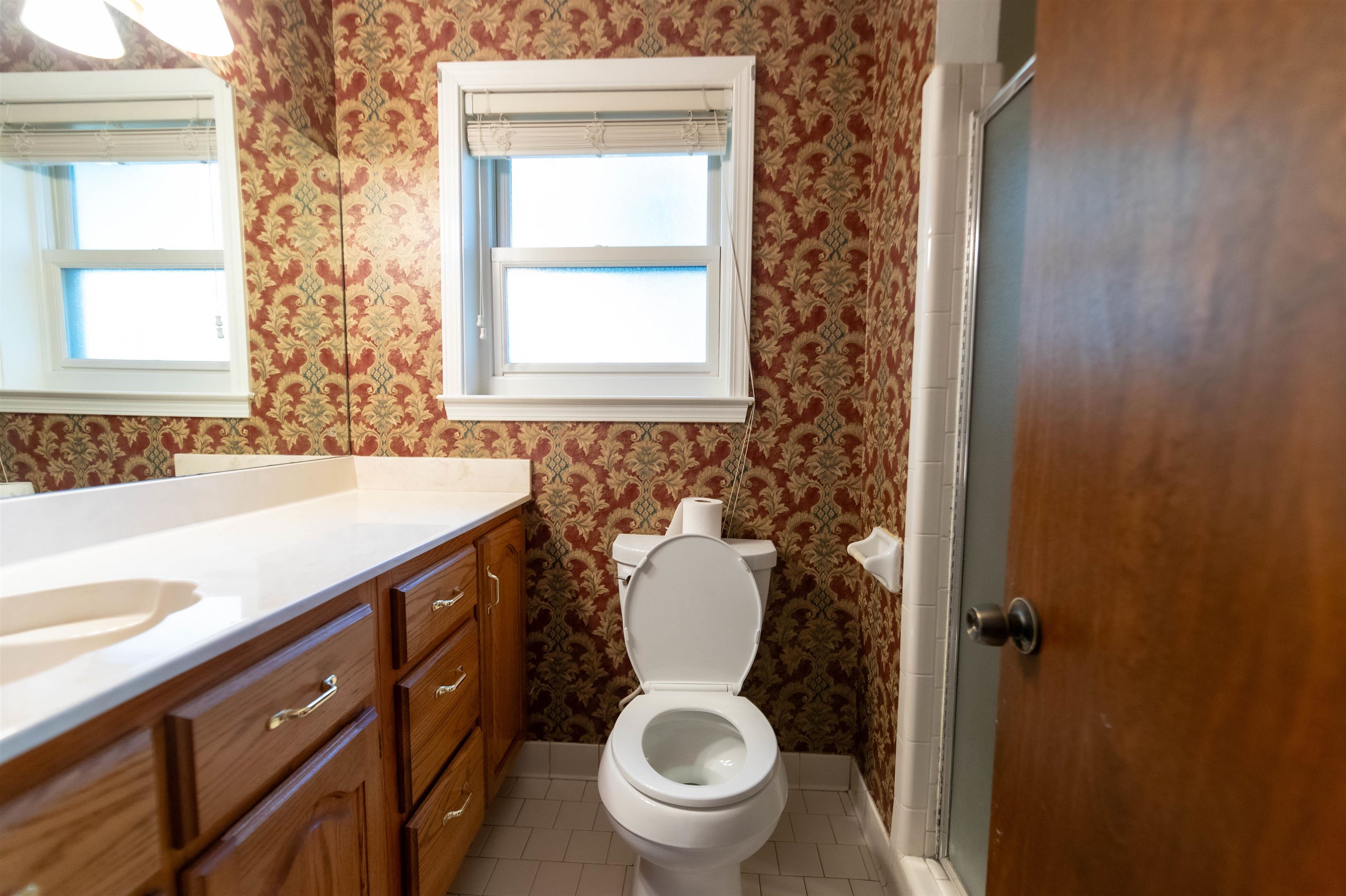 653 Oak Wild Cove Collierville, TN 38017 - Photo 15 of 20 Bathroom featuring a shower with door, toilet, tile patterned floors, and plenty of natural light