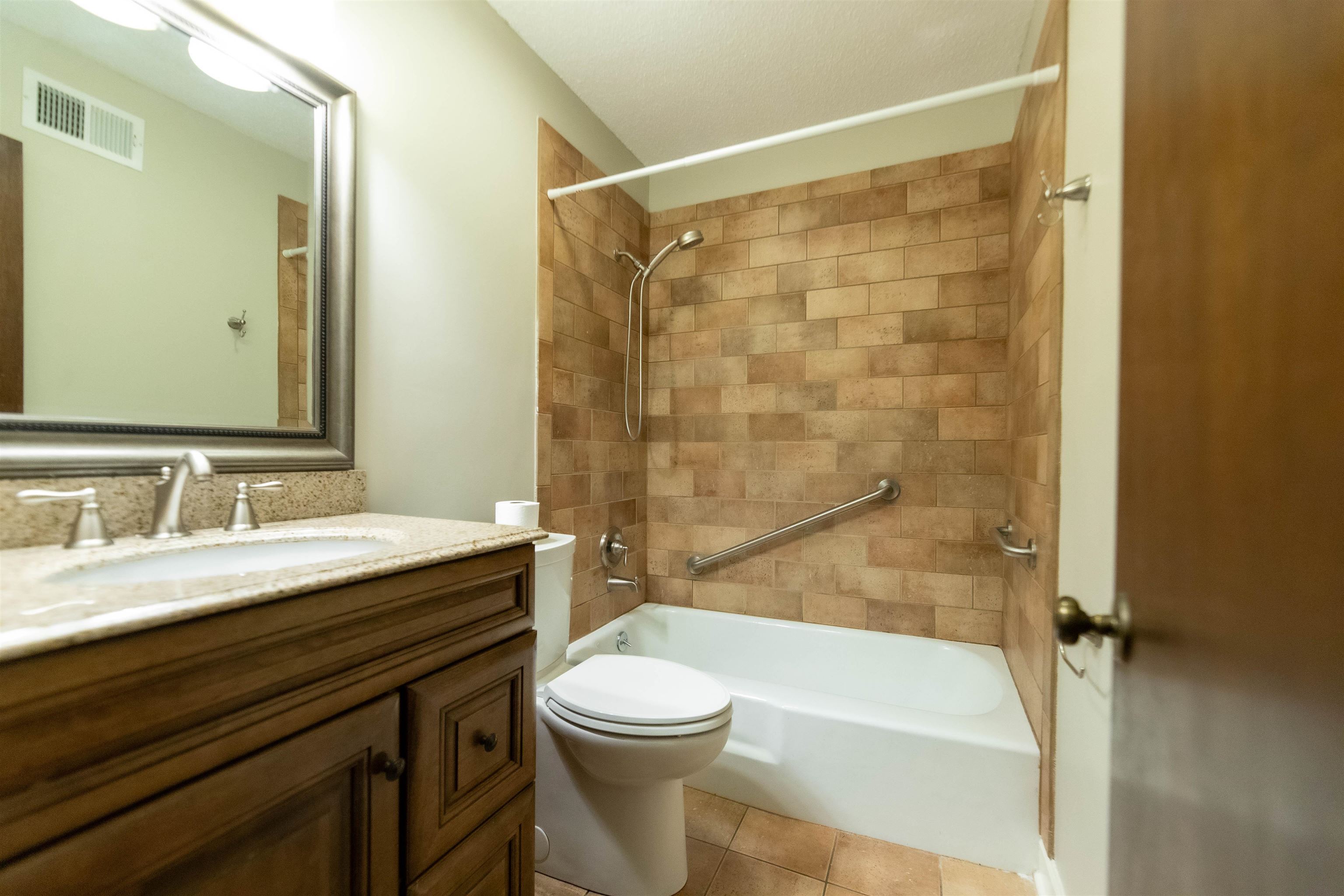 653 Oak Wild Cove Collierville, TN 38017 - Photo 19 of 20 Full bathroom featuring vanity, toilet, tile patterned floors, and tiled shower / bath