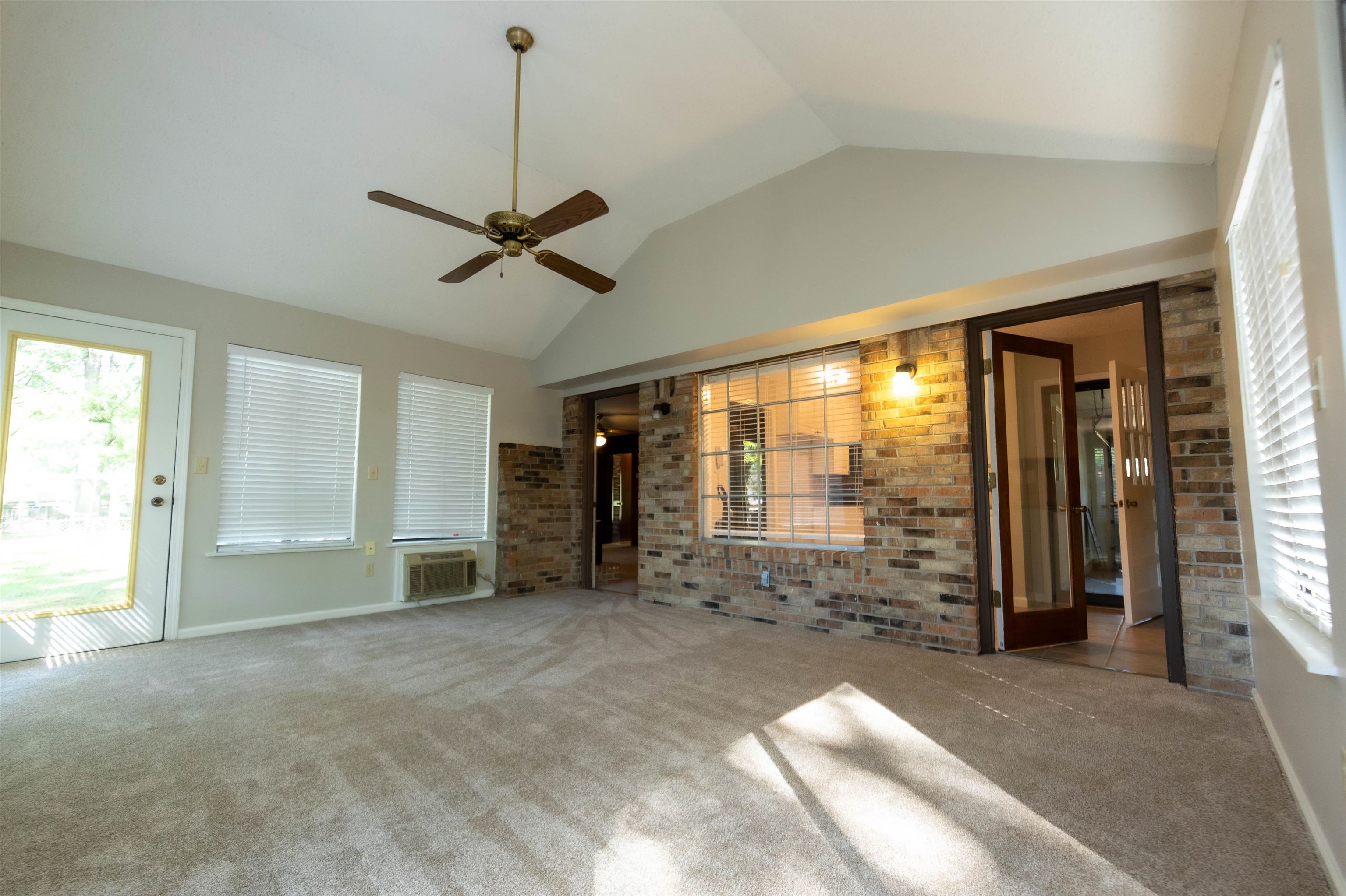 653 Oak Wild Cove Collierville, TN 38017 - Photo 4 of 20 Unfurnished living room with a wealth of natural light, ceiling fan, carpet flooring, and a wall mounted AC