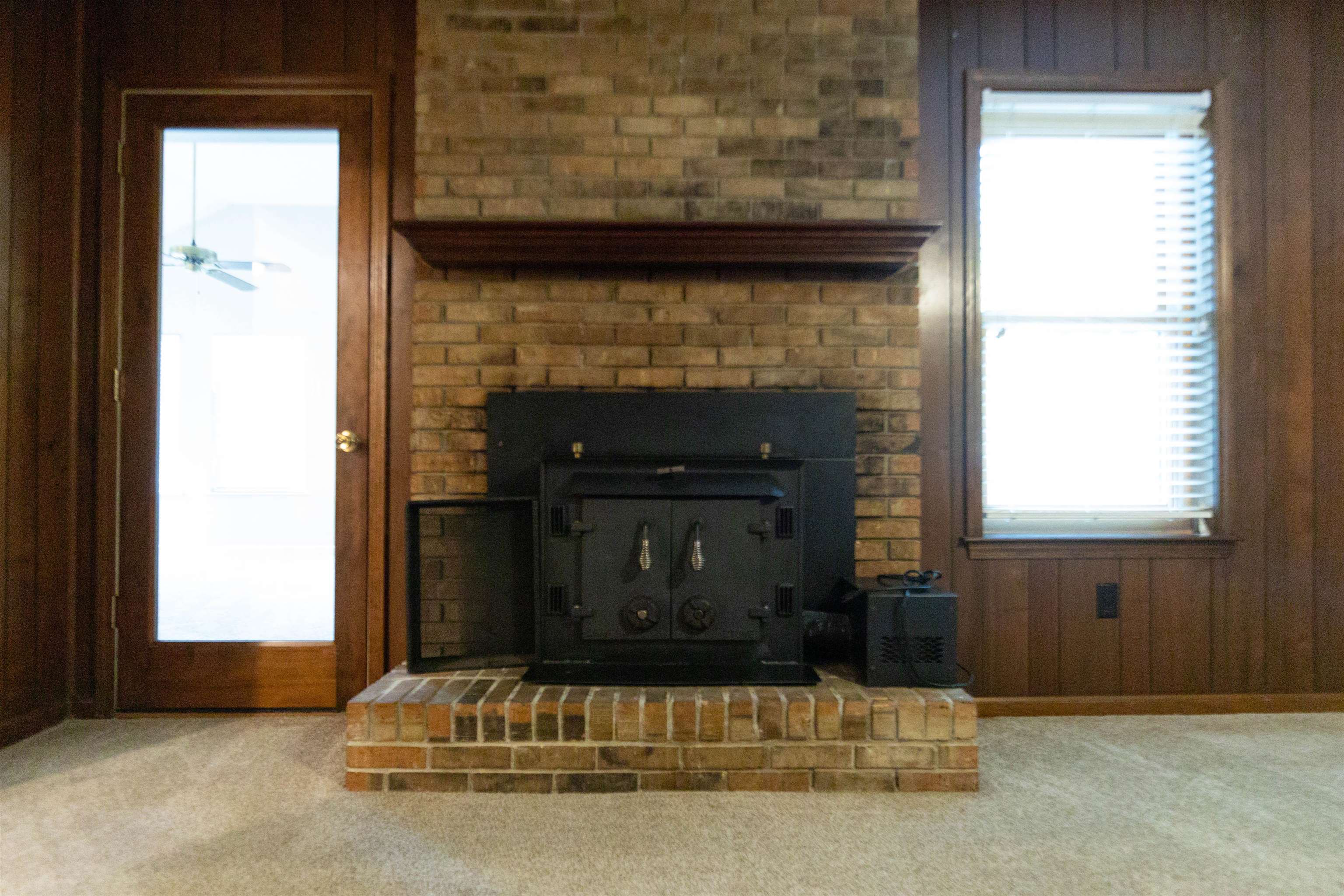 653 Oak Wild Cove Collierville, TN 38017 - Photo 7 of 20 Interior details with carpet, wooden walls, and ceiling fan