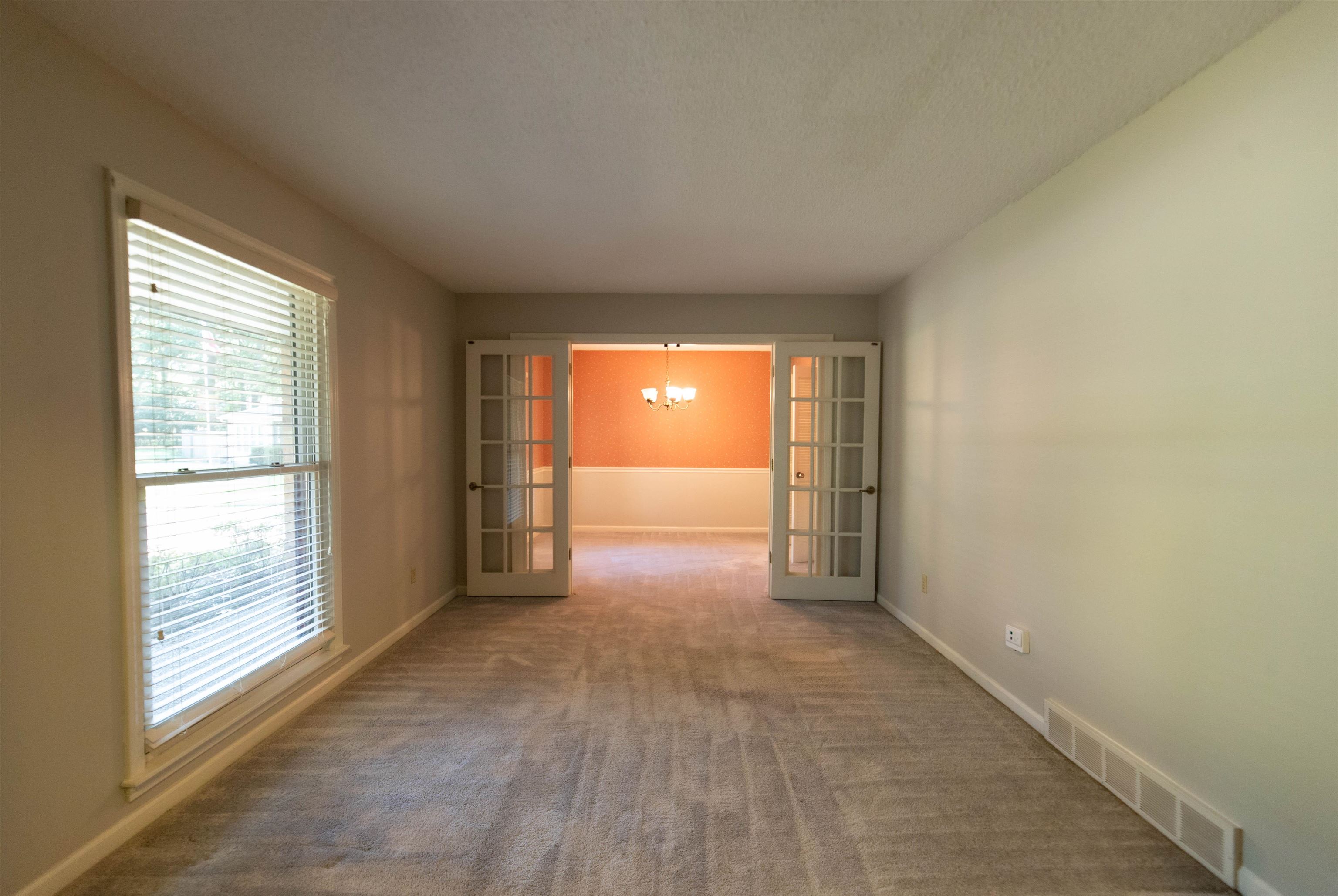 653 Oak Wild Cove Collierville, TN 38017 - Photo 9 of 20 Spare room featuring carpet floors, a textured ceiling, and french doors