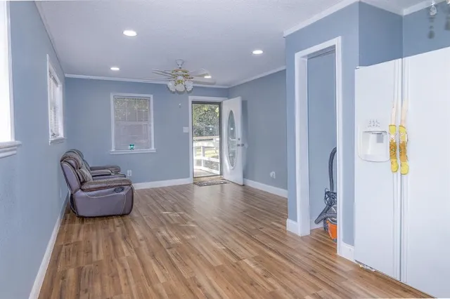 a living room with furniture and a wooden floor