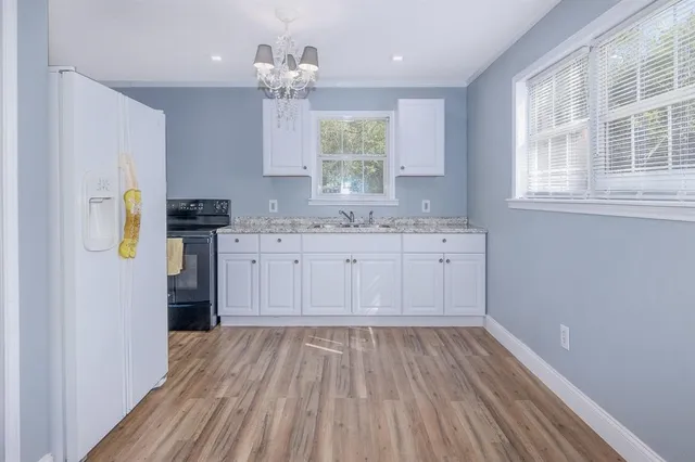 a kitchen with a sink window and stainless steel appliances