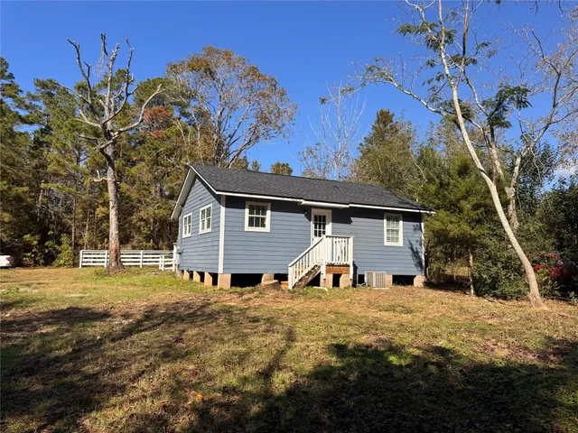 a view of a house with a yard covered in snow