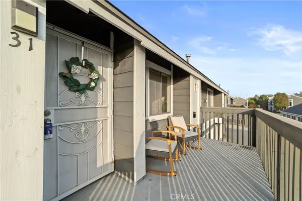 a balcony with table and chairs