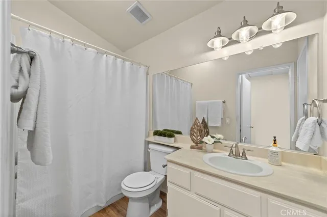 a bathroom with a sink a toilet and mirror