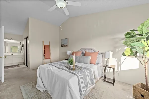 a bedroom with bed and a chandelier