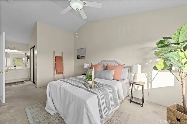 a bedroom with bed and a chandelier