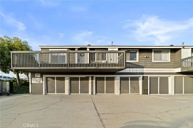 a front view of a house with glass windows and a yard