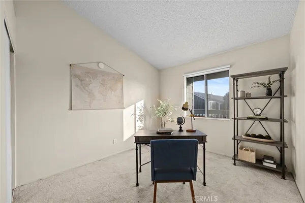 a dining room with furniture and a floor to ceiling window