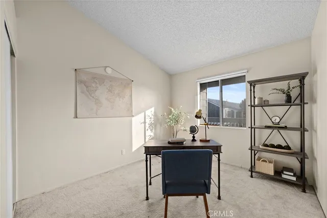 a dining room with furniture and a floor to ceiling window