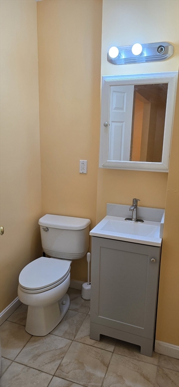 403 South Main Street, Unit 1 Sharon, MA 02067 - Photo 12 of 16 a bathroom with a toilet a sink and mirror
