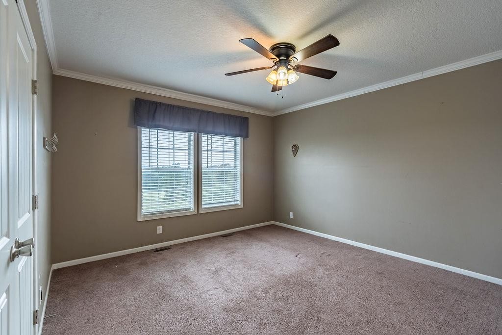 321 Archie Lane Dawson Springs, KY 42408 - Photo 14 of 42 an empty room with chandelier fan and windows