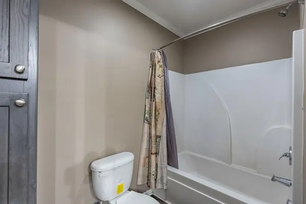 a bathroom with a shower and a toilet