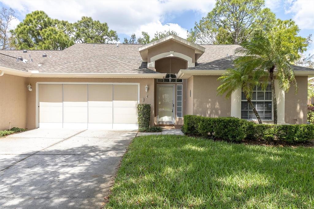 7527 Moorgate Court New Port Richey, FL 34654 - Photo 1 of 1 a front view of a house with a yard and garage