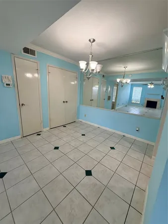a view of a hallway with chandelier