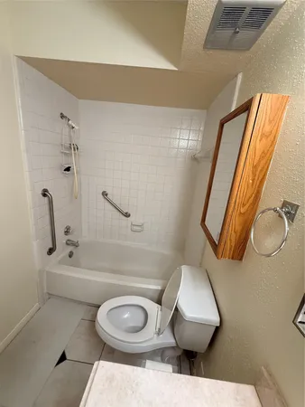 a bathroom with a toilet and a mirror