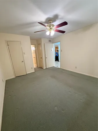 a view of a livingroom with a ceiling fan and window