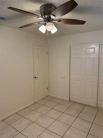 a view of a room that has a fan and a chandelier fan