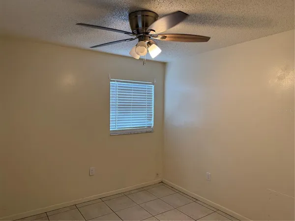a view of a livingroom with a ceiling fan and window