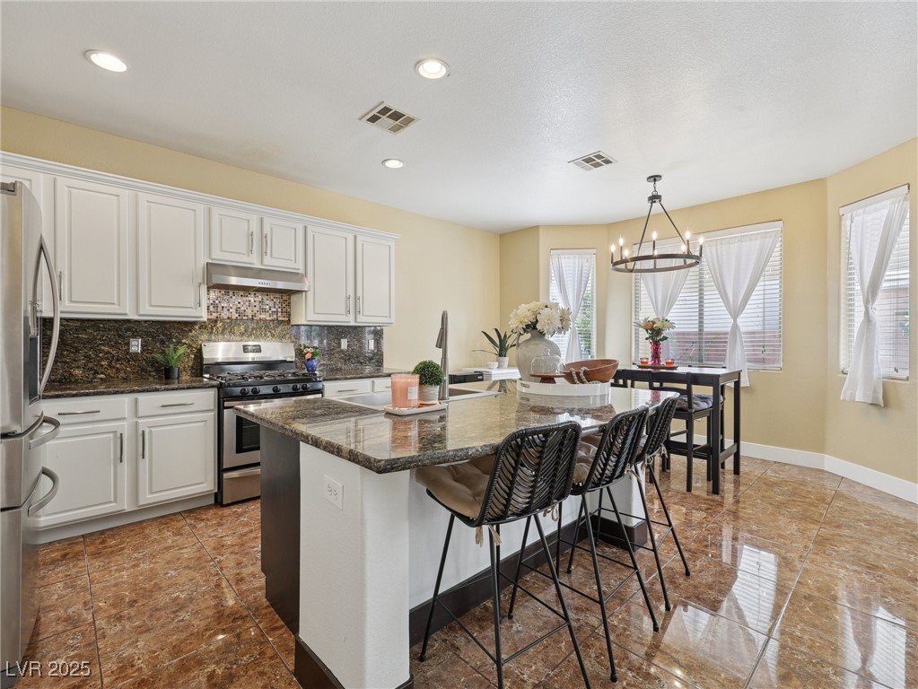 5437 Raccoon Valley Lane Las Vegas, NV 89122 - Photo 2 of 44 Large open kitchen with island & separate seating area.