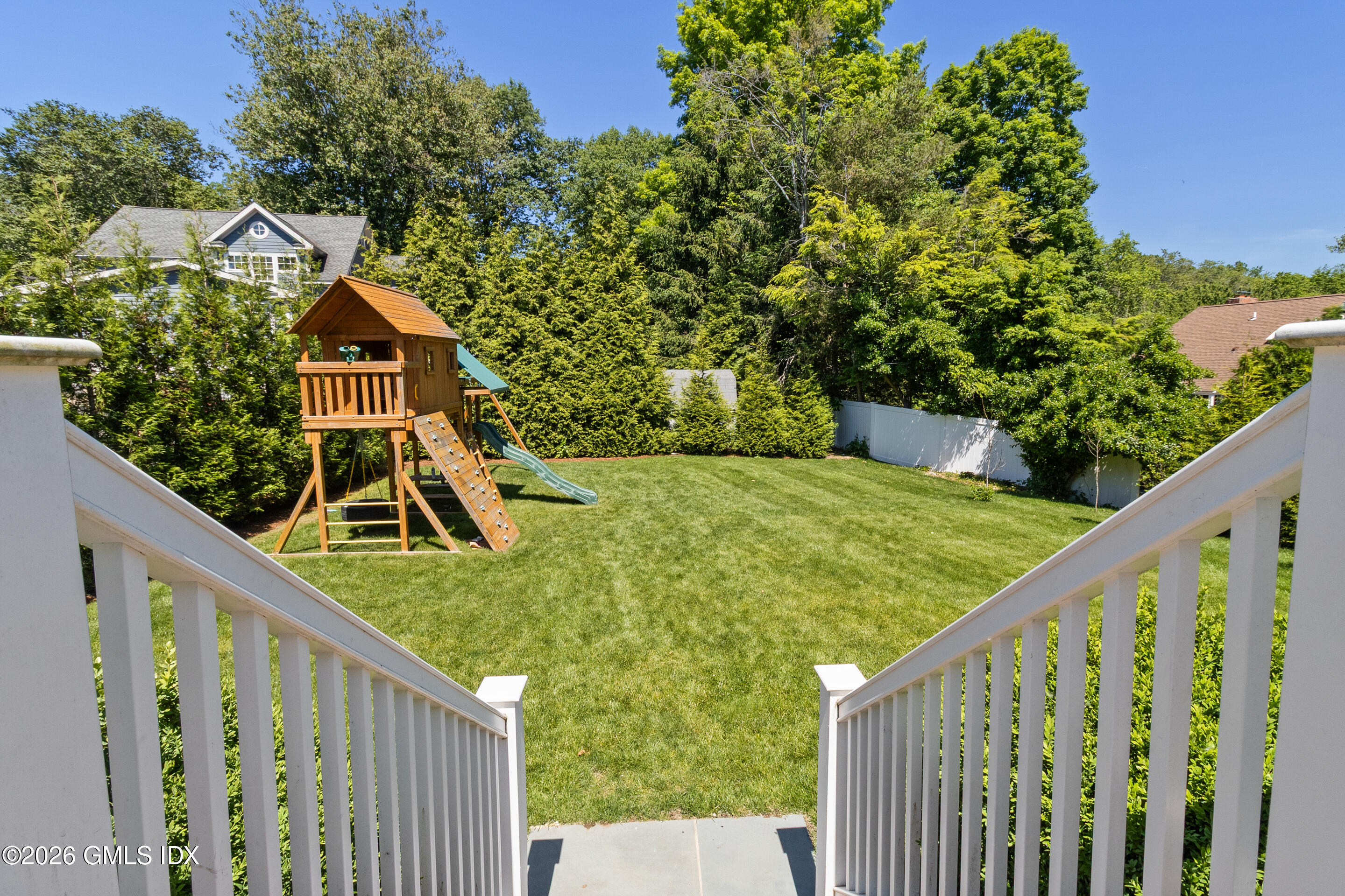 9 Deluca Drive Cos Cob, CT 06807 - Photo 25 of 30 a view of a small yard in front of a house with wooden fence