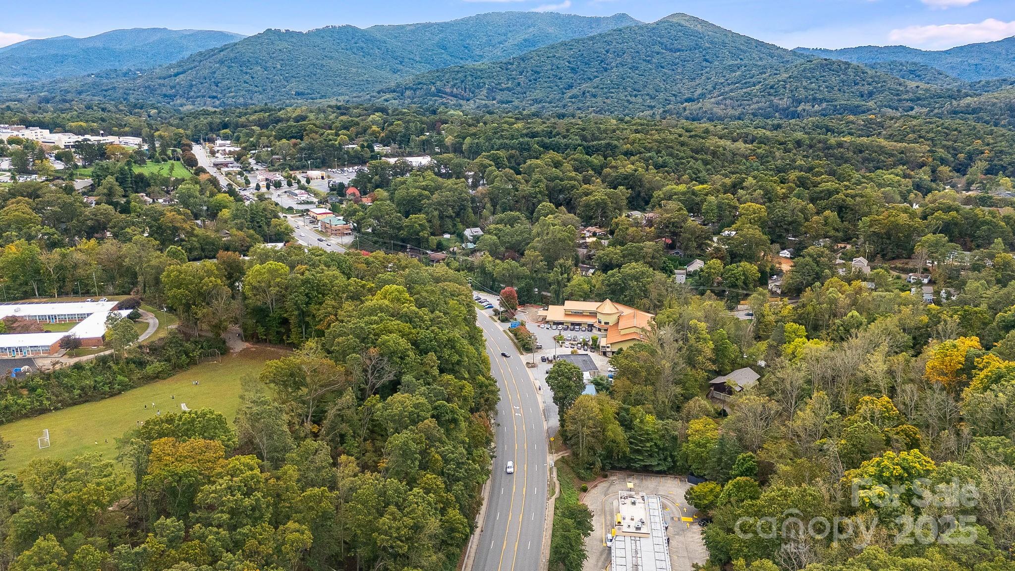 455 Governors View Road Asheville, NC 28805 - Photo 22 of 26 a view of a house with a mountain in the background