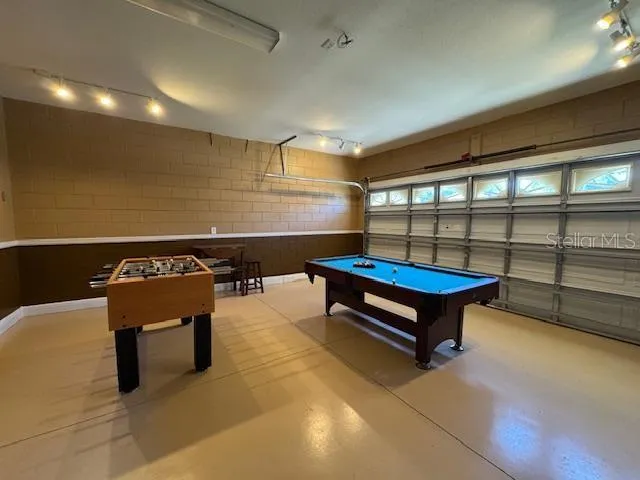 a reading room with furniture and a rug