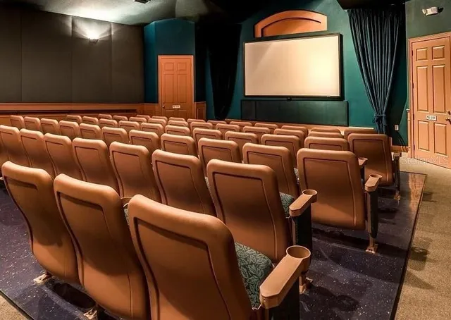 a media room with lots of chairs and a projector screen