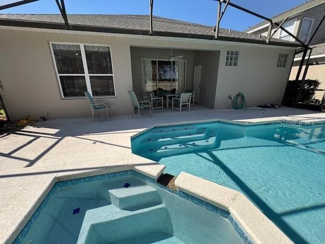 a view of a swimming pool with chairs