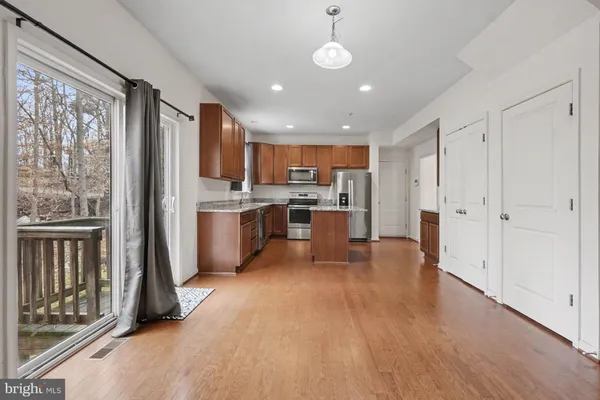 a view of an entryway with wooden floor
