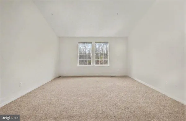 a view of an empty room and closet area