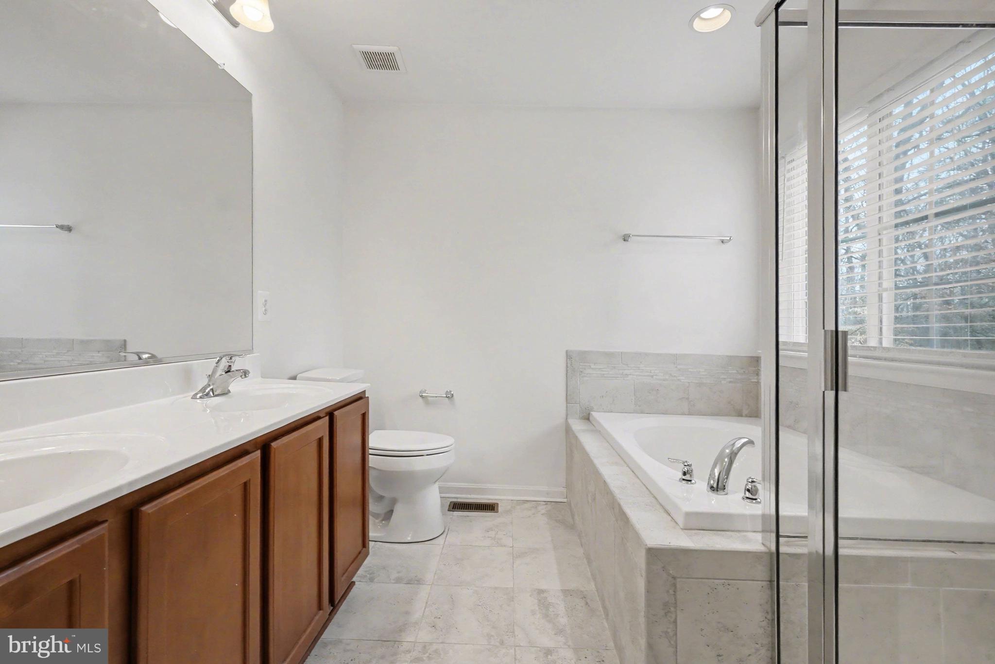 35 Sparrows Way Elkton, MD 21921 - Photo 19 of 36 a bathroom with a sink and mirror with toilet