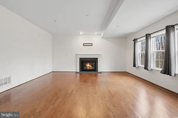 wooden floor in an empty room with a fireplace