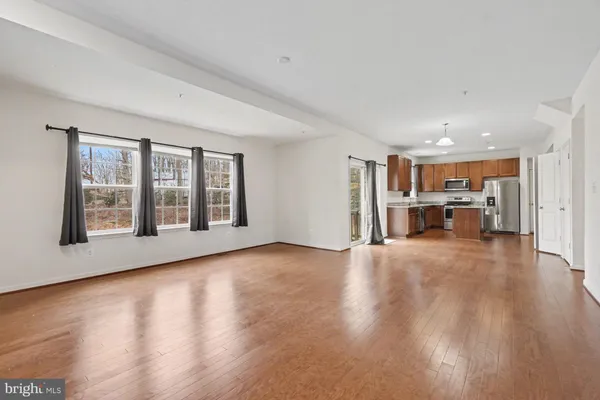 a view of work space with wooden floor and windows