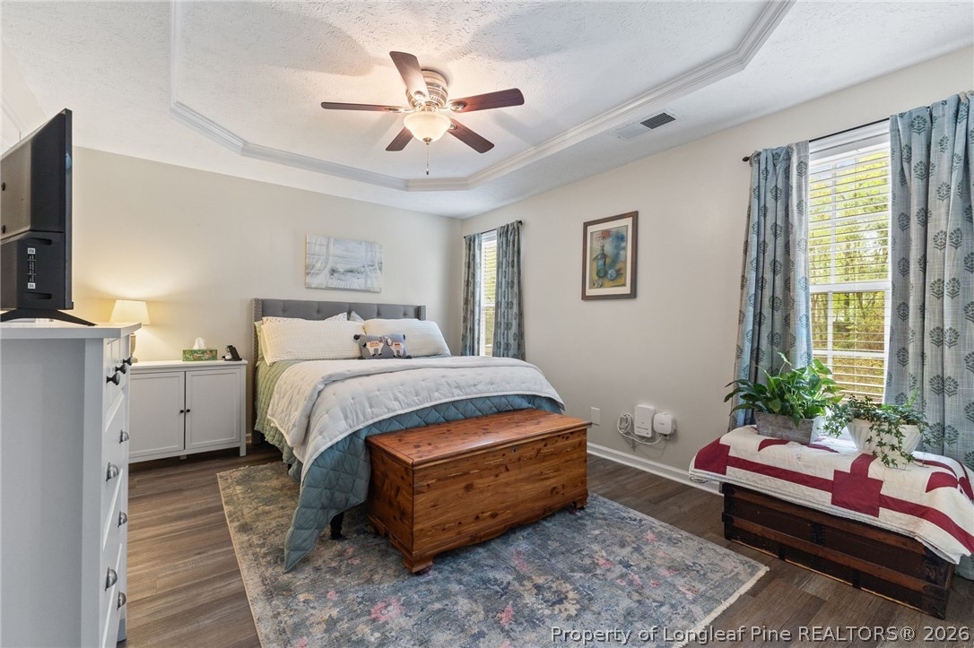 122 Raymond Street Raeford, NC 28376 - Photo 17 of 36 a bedroom with a bed and a chandelier