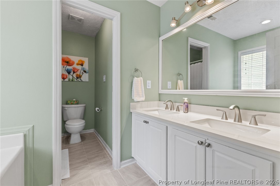 122 Raymond Street Raeford, NC 28376 - Photo 19 of 36 a bathroom with a sink and a mirror