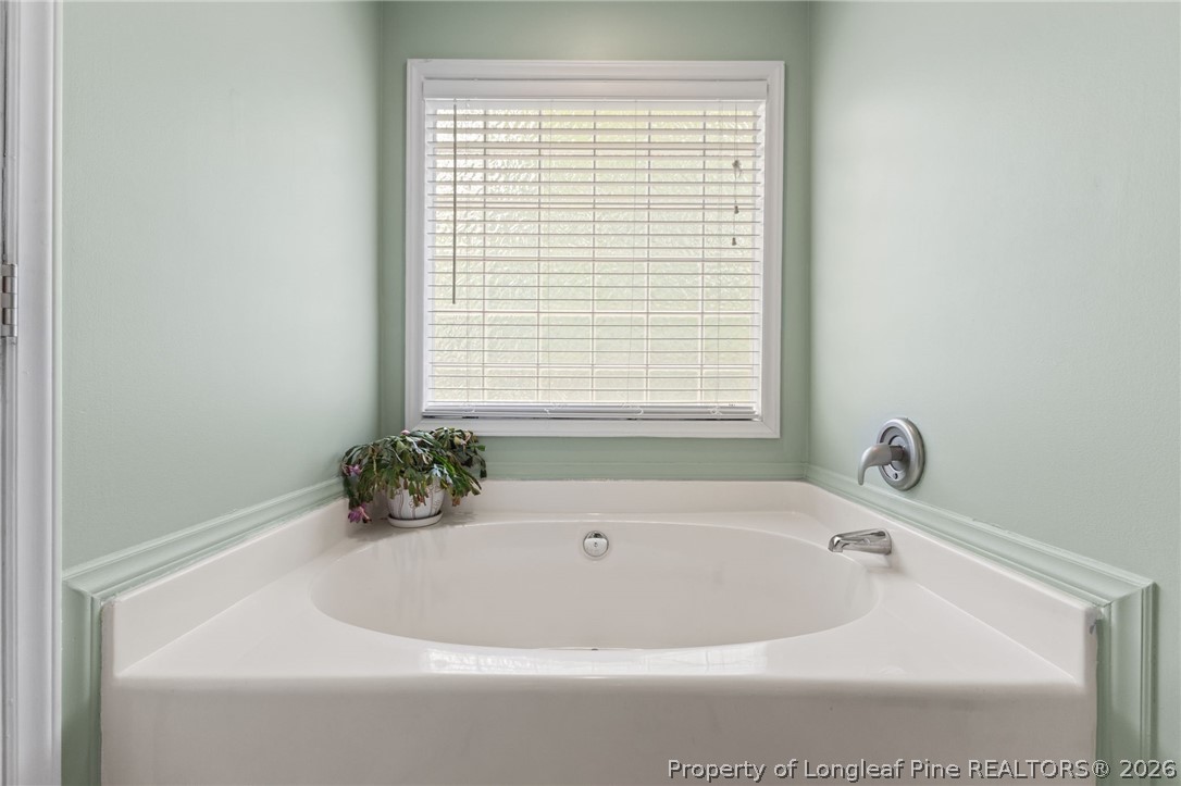 122 Raymond Street Raeford, NC 28376 - Photo 20 of 36 a white bath tub sitting in a bathroom next to a window