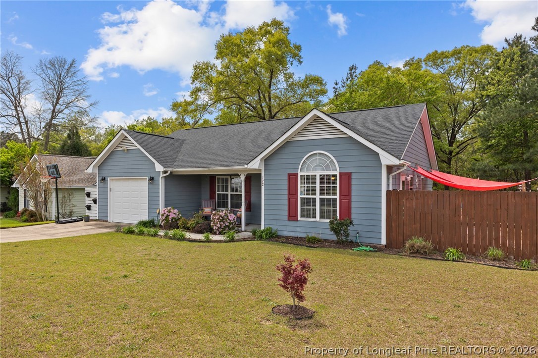 122 Raymond Street Raeford, NC 28376 - Photo 2 of 36 a front view of house with yard and trees in the background
