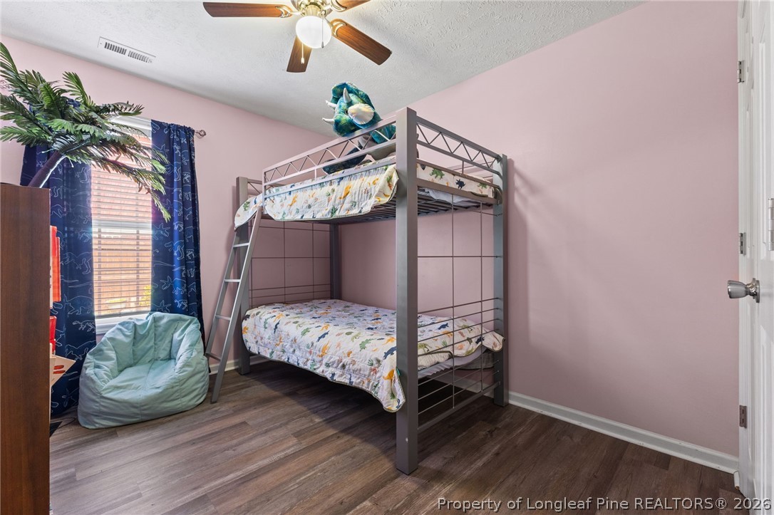 122 Raymond Street Raeford, NC 28376 - Photo 21 of 36 a bedroom with a bed and a chandelier