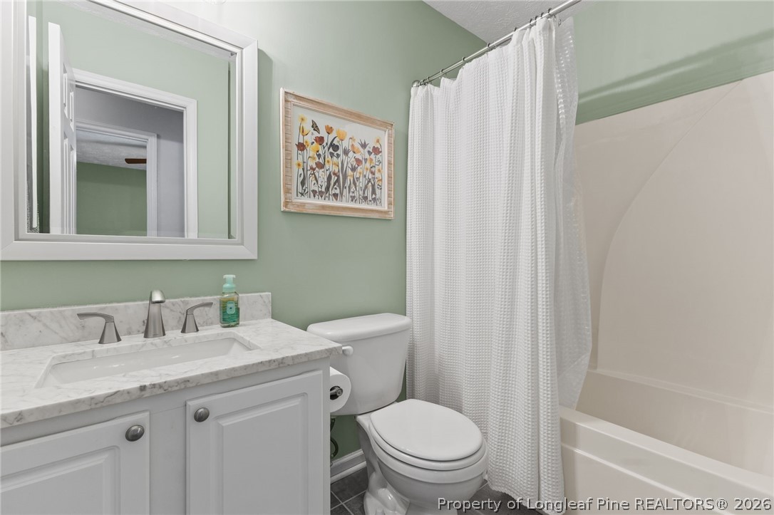 122 Raymond Street Raeford, NC 28376 - Photo 22 of 36 a bathroom with a granite countertop sink toilet and a mirror