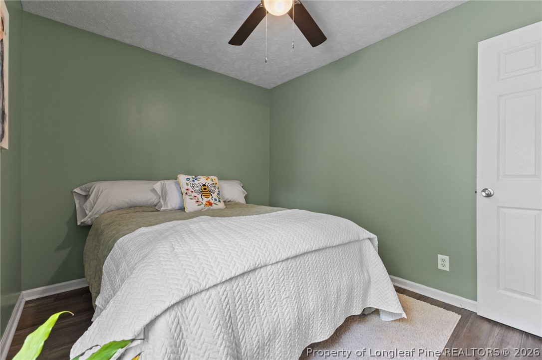 122 Raymond Street Raeford, NC 28376 - Photo 23 of 36 a bedroom with a bed and painting on the wall