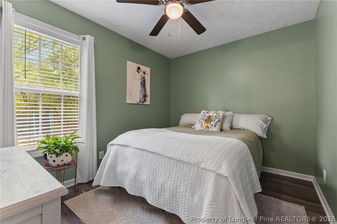 122 Raymond Street Raeford, NC 28376 - Photo 24 of 36 a bedroom with a bed and a potted plant
