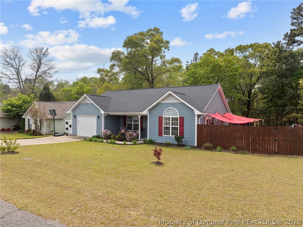 122 Raymond Street Raeford, NC 28376 - Photo 3 of 36 a front view of house with yard and trees in the background