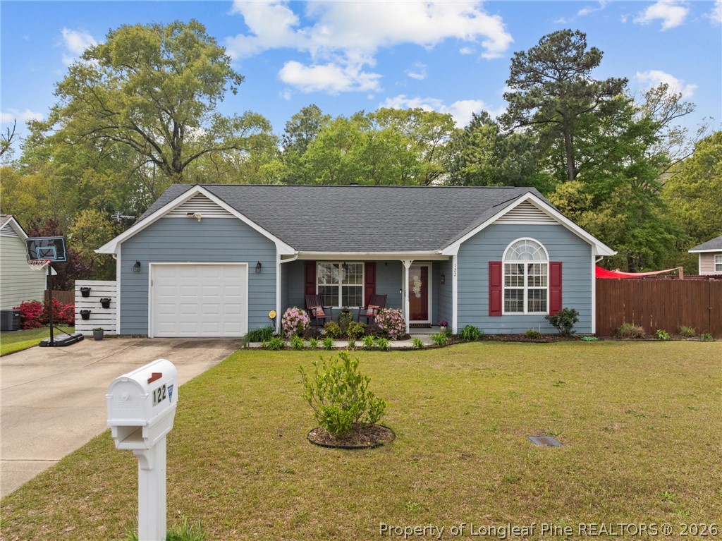 122 Raymond Street Raeford, NC 28376 - Photo 32 of 36 a front view of house with yard outdoor seating and green space