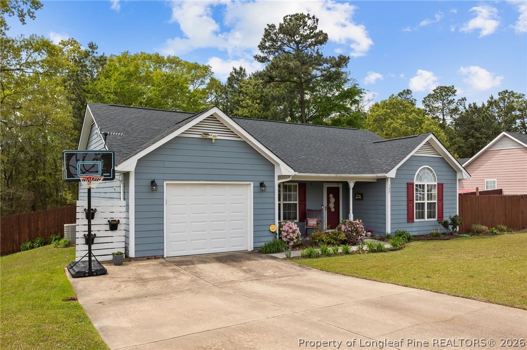 122 Raymond Street Raeford, NC 28376 - Photo 4 of 36 a front view of a house with a yard and garage